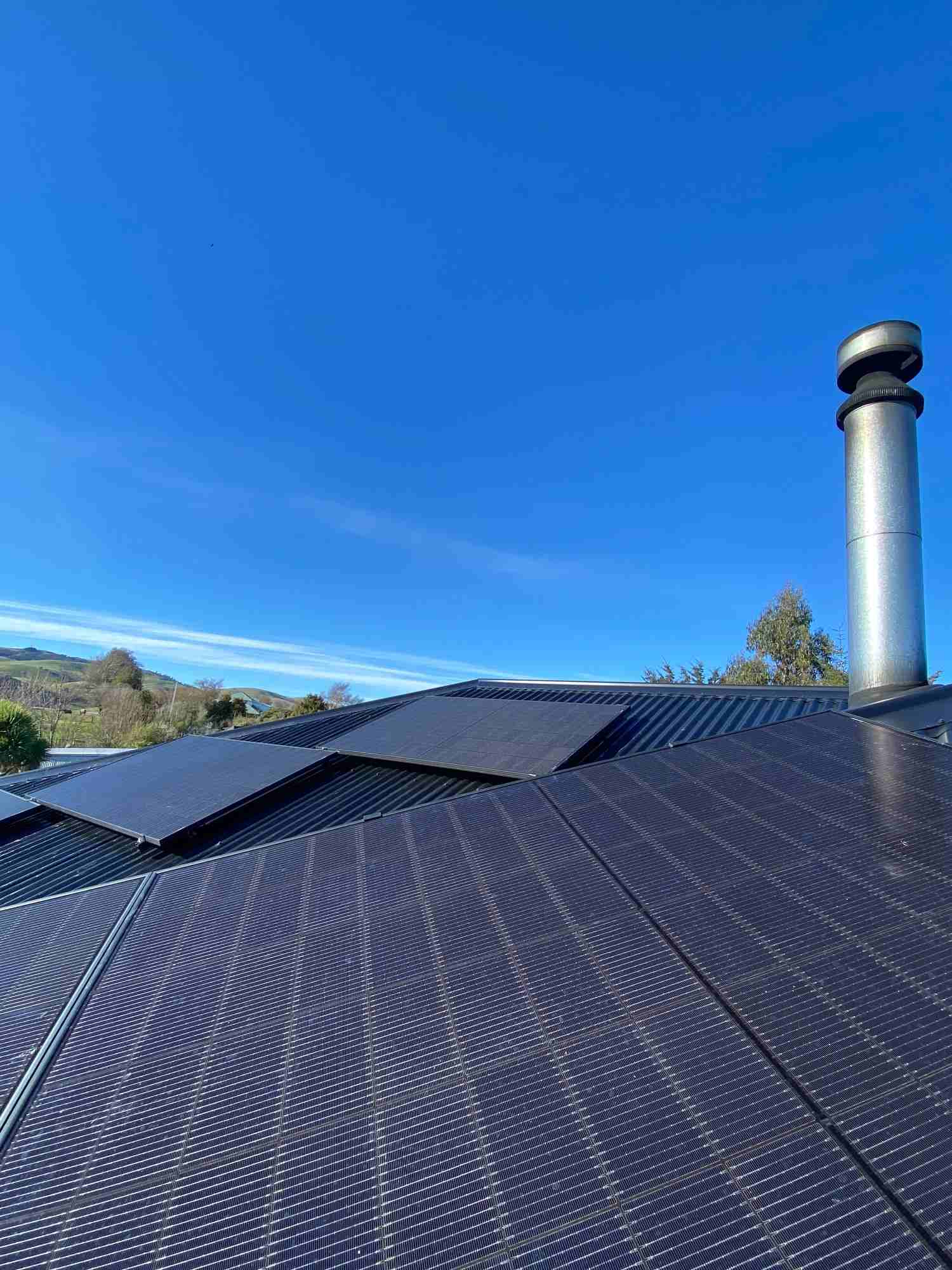 Solar array on a large roof under blue sky